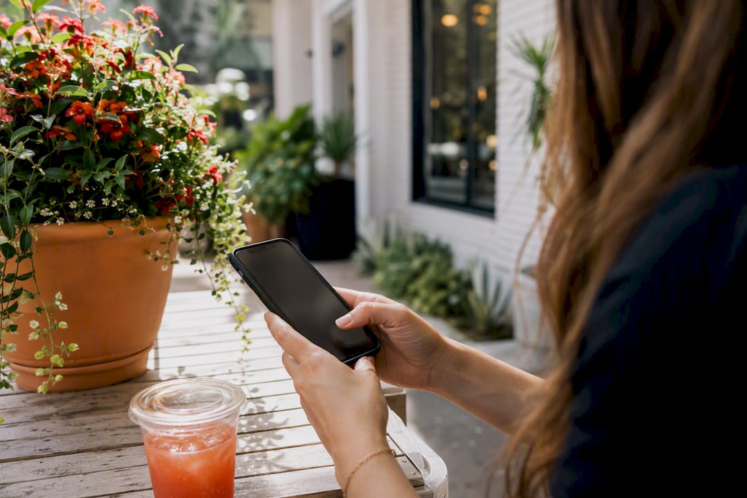 Hands typing message on smartphone in salon