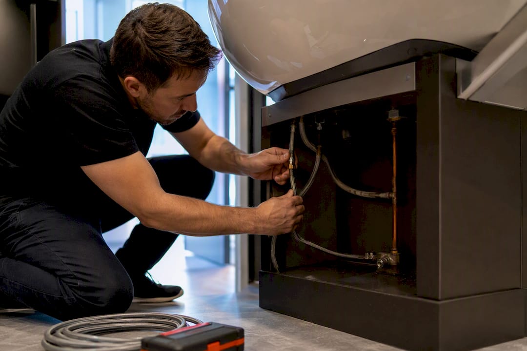 Technician inspecting salon plumbing