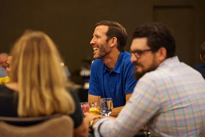 man laughing with others