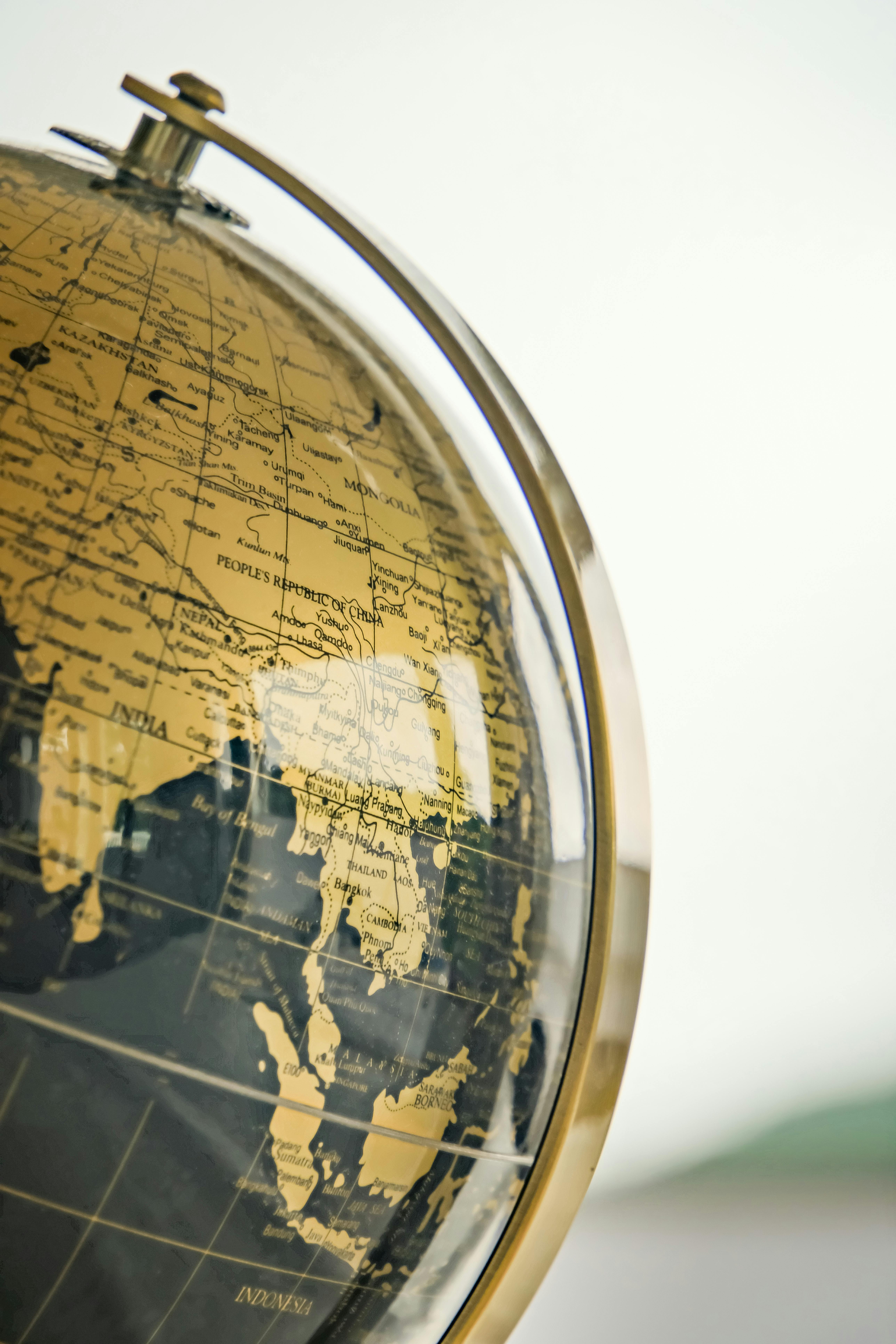 Close-up of a globe focusing on Southeast Asia including China, India, Thailand, and Indonesia.