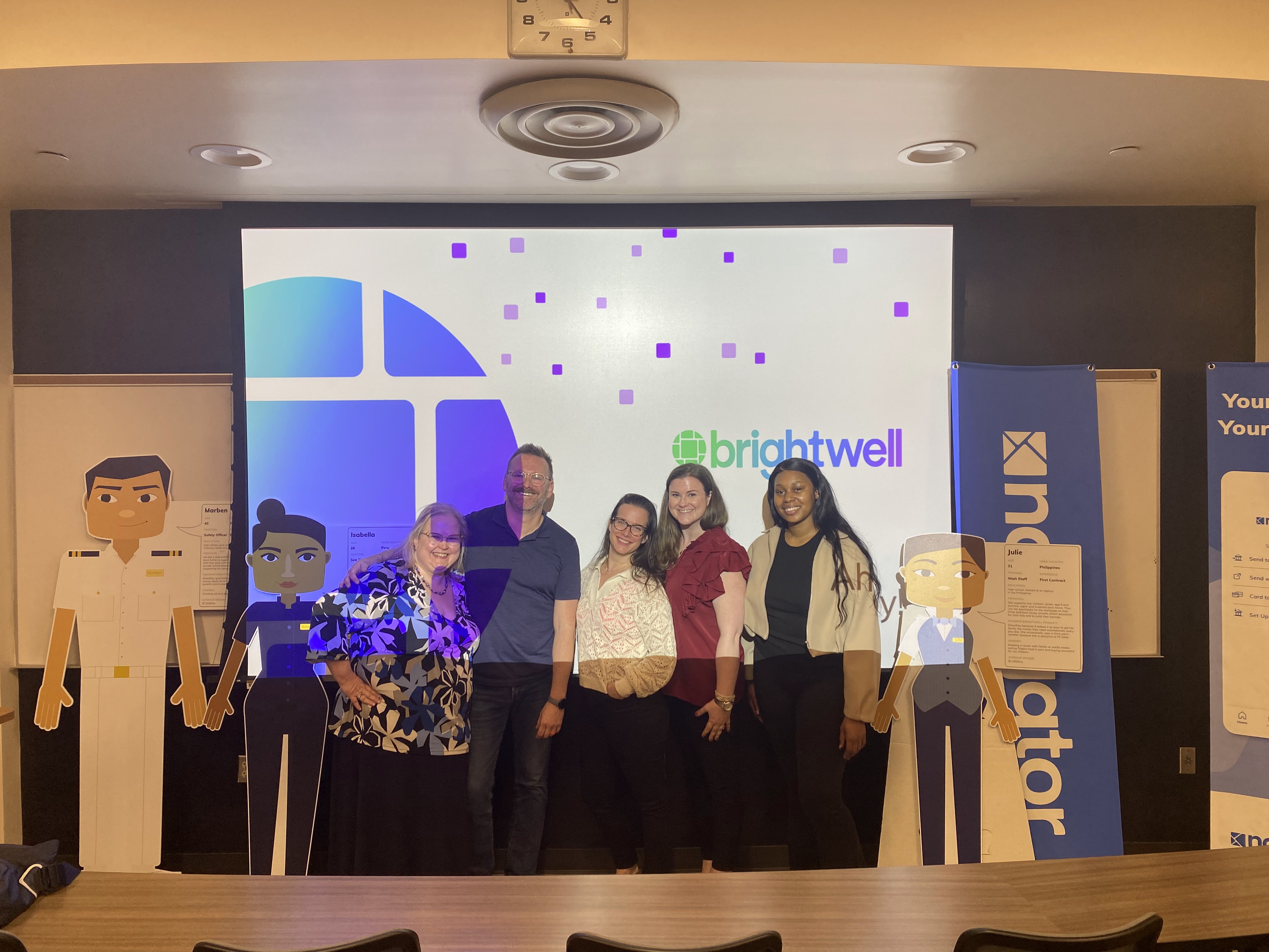 Kennesaw State University professor Tyra Burton stands onstage with the Brightwell marketing team (Joe Bechely, Kelly O'Malley, Sarah Davis, and Jacqueline Adoghe) following their presentation at the school about international business marketing. Brightwell is a fintech company and global payments enabler dedicated to providing financial access to people all over the world.