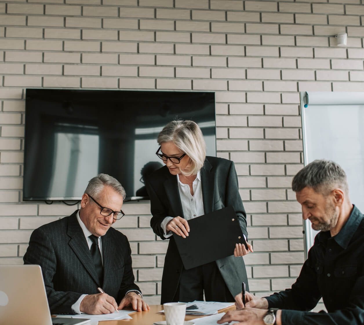 Two man are wrighting in paper