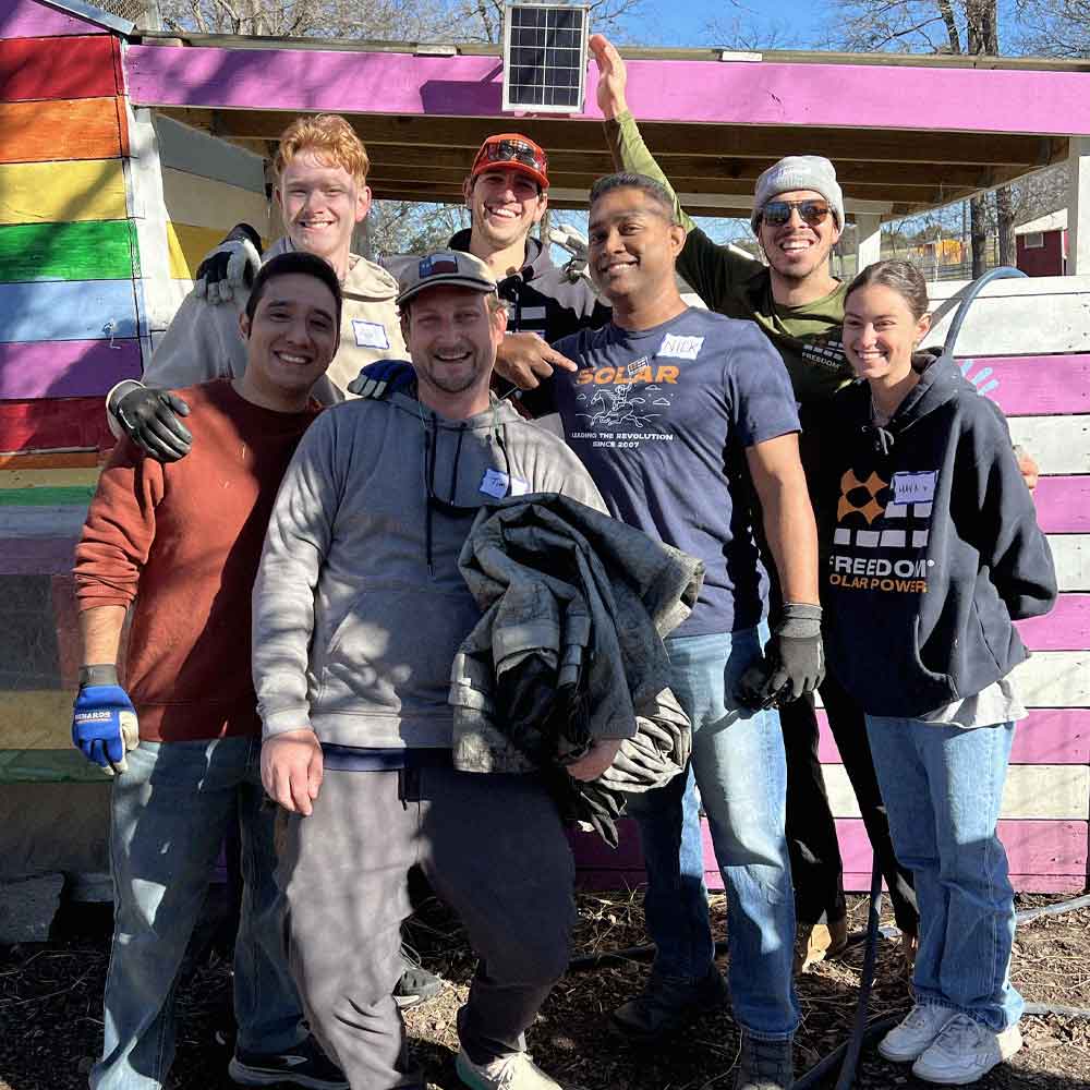 Freedom Power team members posing in a group photo during a volunteer event