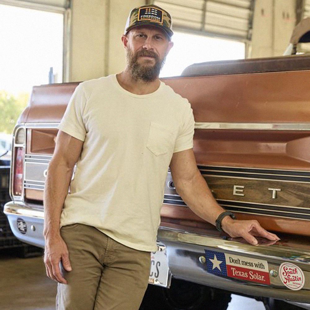 Bret Biggart, CEO of Freedom Power, posing in front of a truck
