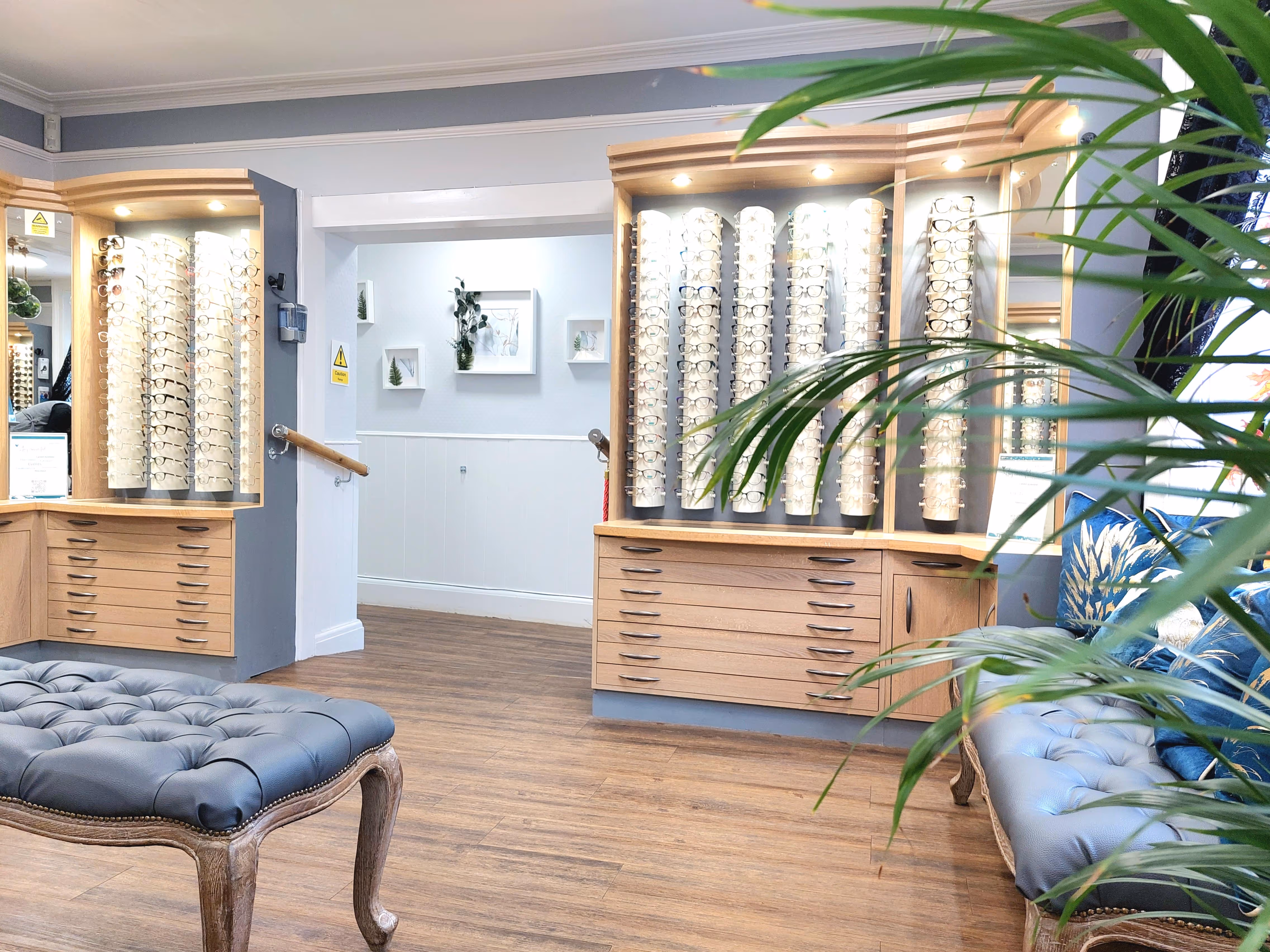 Spacious optical practice waiting area with eyeglass displays and elegant seating
