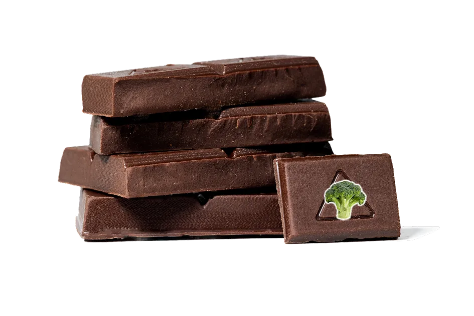 Stack of dark chocolate bars with one bar featuring an embossed broccoli icon.