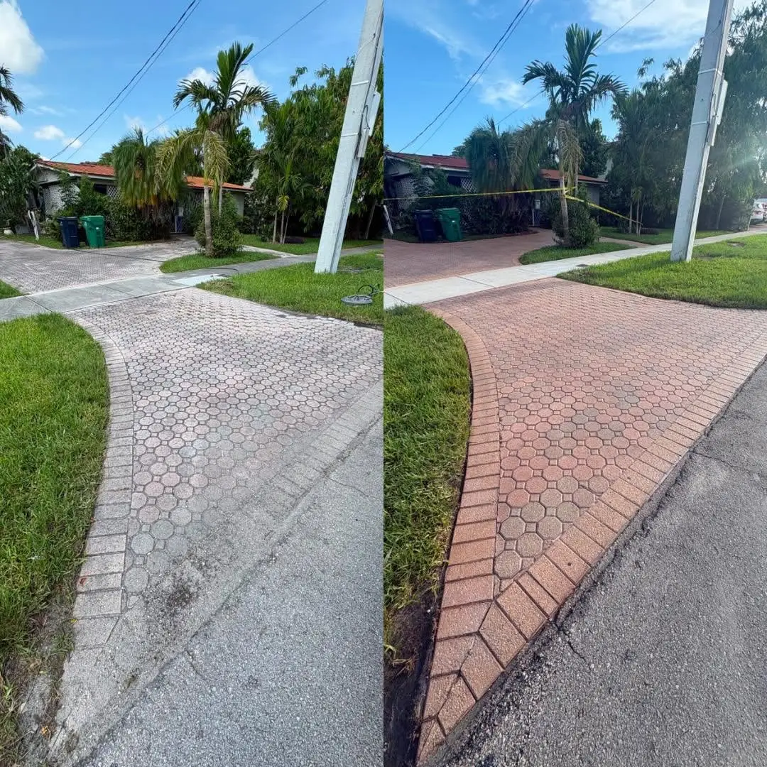 Person using a surface cleaner to pressure wash wet terracotta floor tiles near a pool.