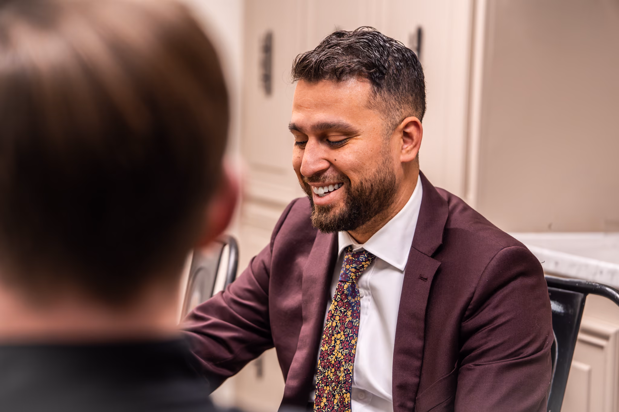 Ramon Damas sitting at a table talking to a client.