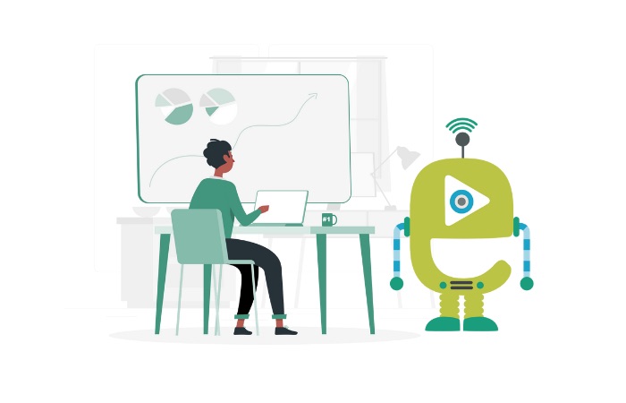 Person sitting at a desk working on a laptop with data charts on a whiteboard, next to a green robot with a Wi-Fi signal icon.