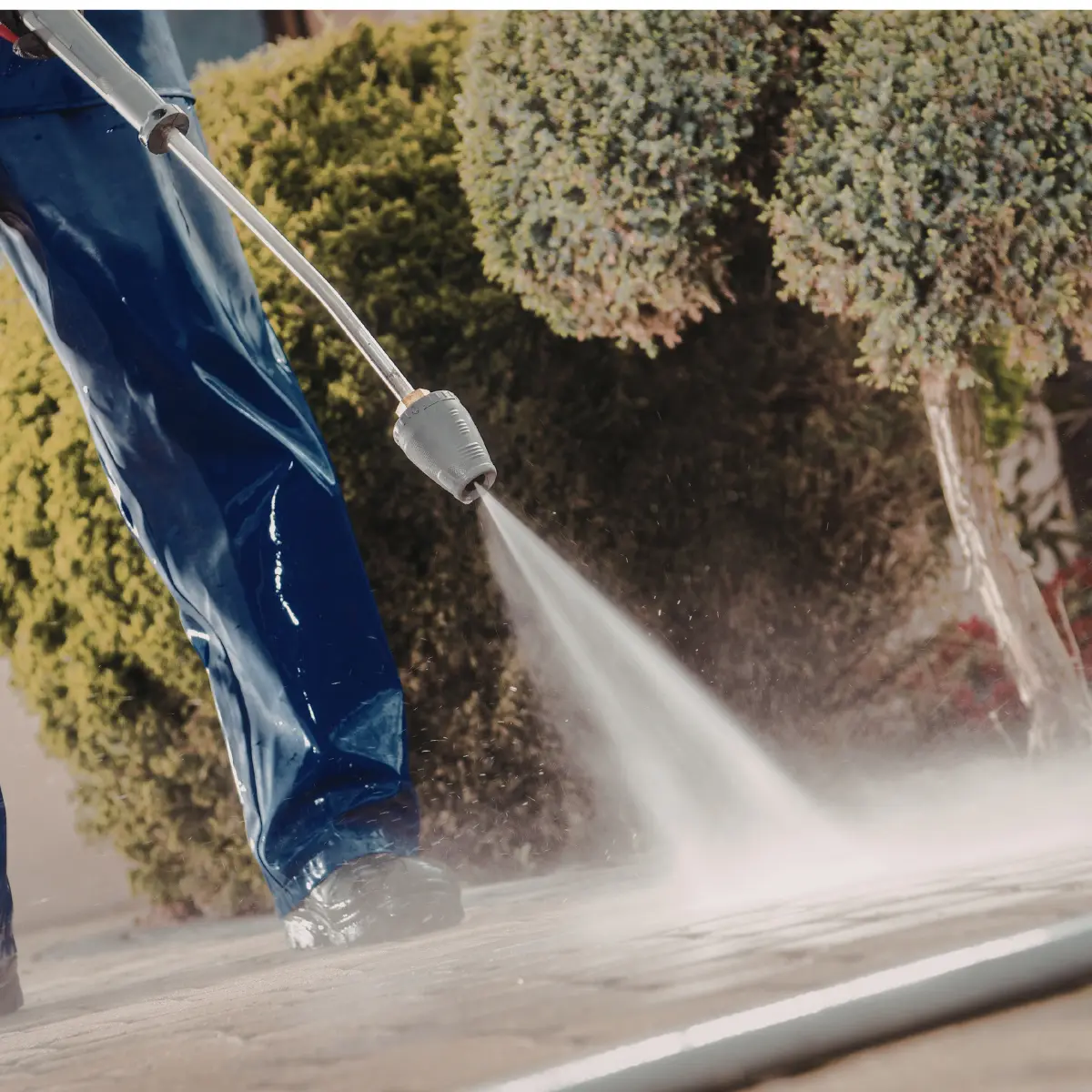 Electric floor cleaning machine scrubbing a wet tiled floor with soap suds around.