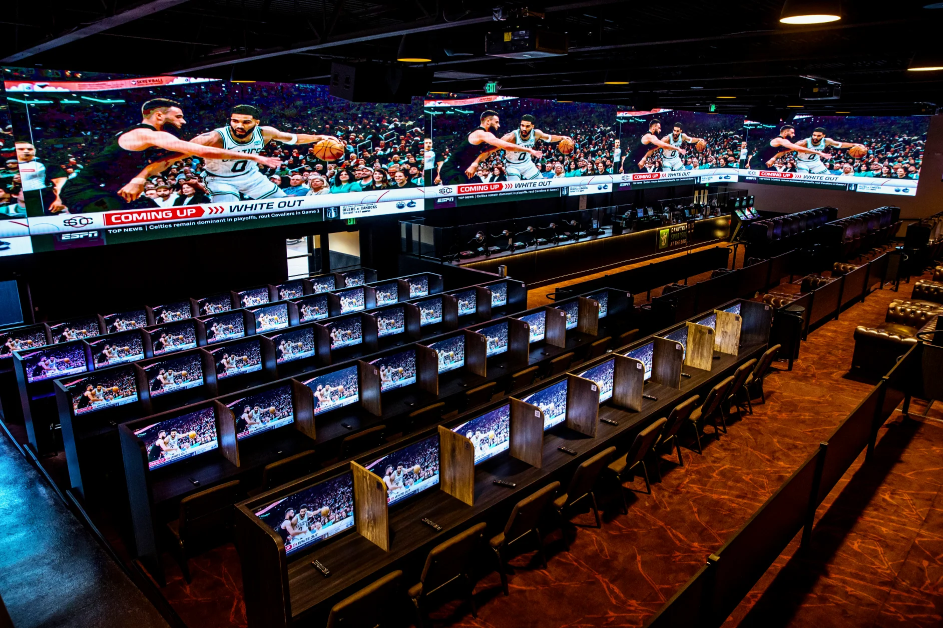 Large tv wall and tv booths at casino.