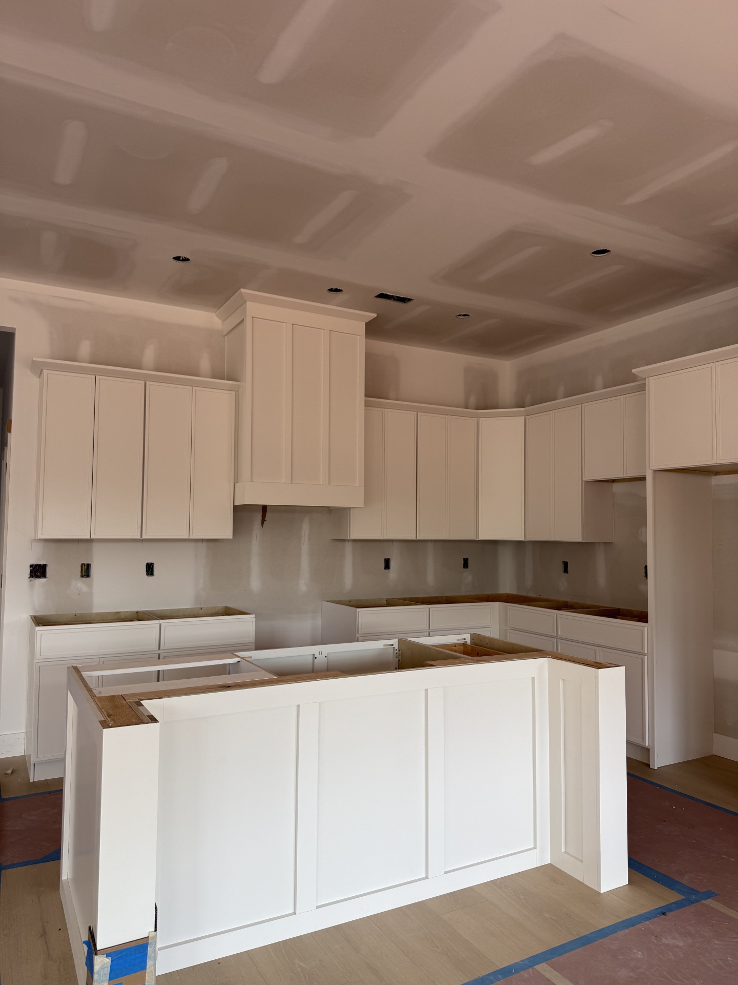 Laundry room with dark wood cabinets, a white countertop with stainless steel sink, and space for washer and dryer hookups.