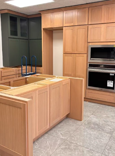 Laundry room with dark wood cabinets, a white countertop with stainless steel sink, and space for washer and dryer hookups.