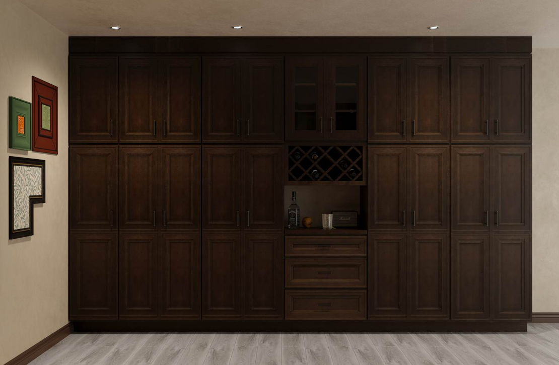 Modern kitchen with dark wood cabinets, stainless steel refrigerator, oven, and hood, a large marble countertop island with hanging pendant lights.