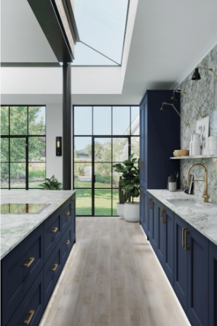 Gray kitchen cabinetry with a built-in wine rack holding three bottles and four hanging wine glasses above a stainless steel faucet and white countertop.