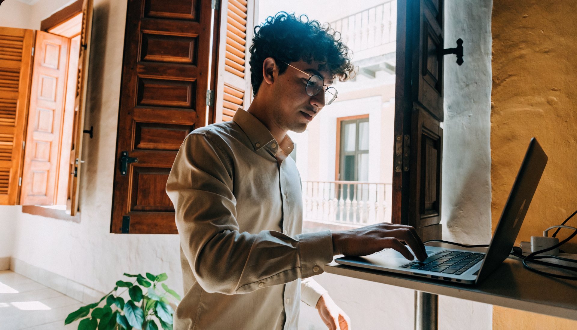 Web designer working at a standing desk in Cartagena