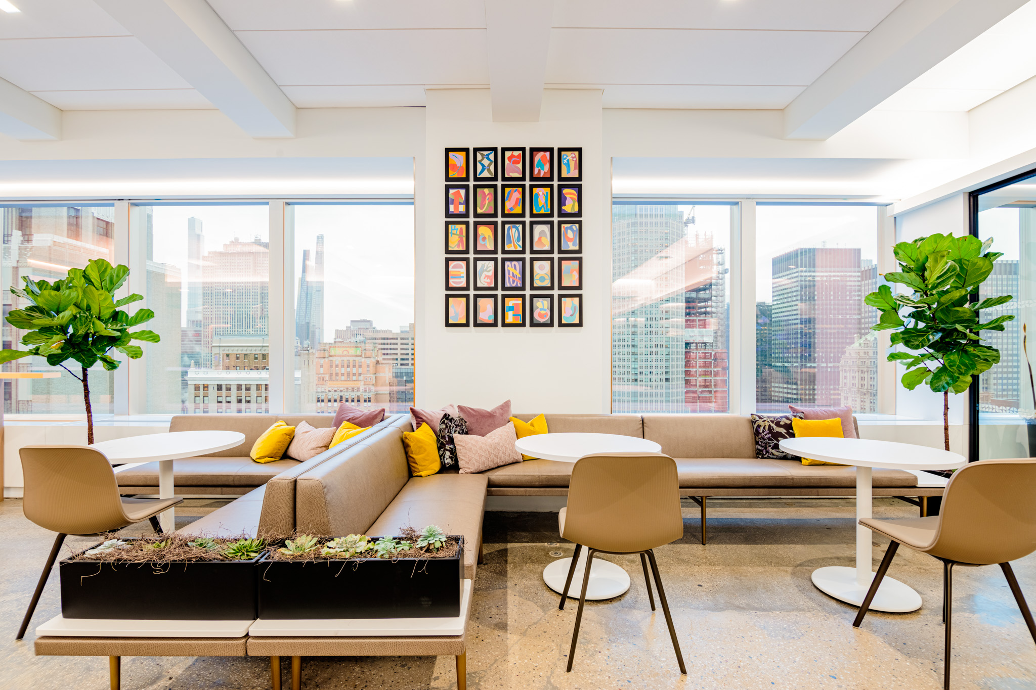 curated gallery wall with colorful art prints in an office space
