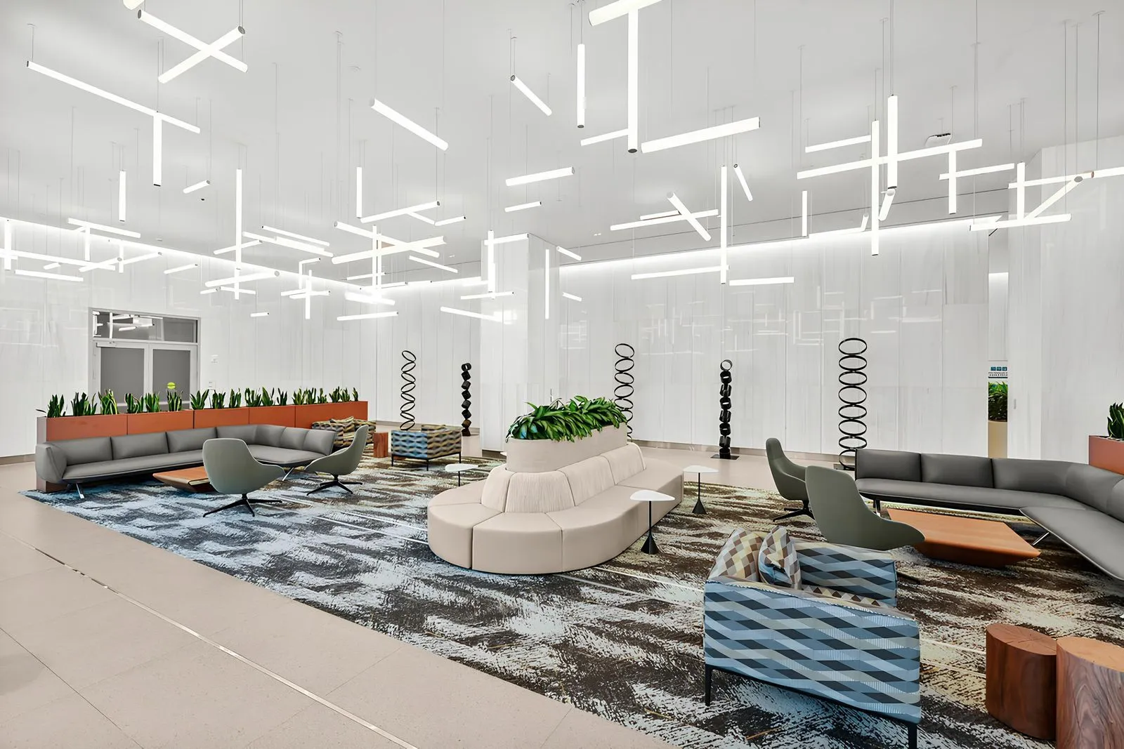 A stylish, modern workspace with a sleek wooden desk, a desktop computer, a notebook, and a potted plant placed beside a large window with ample natural light.