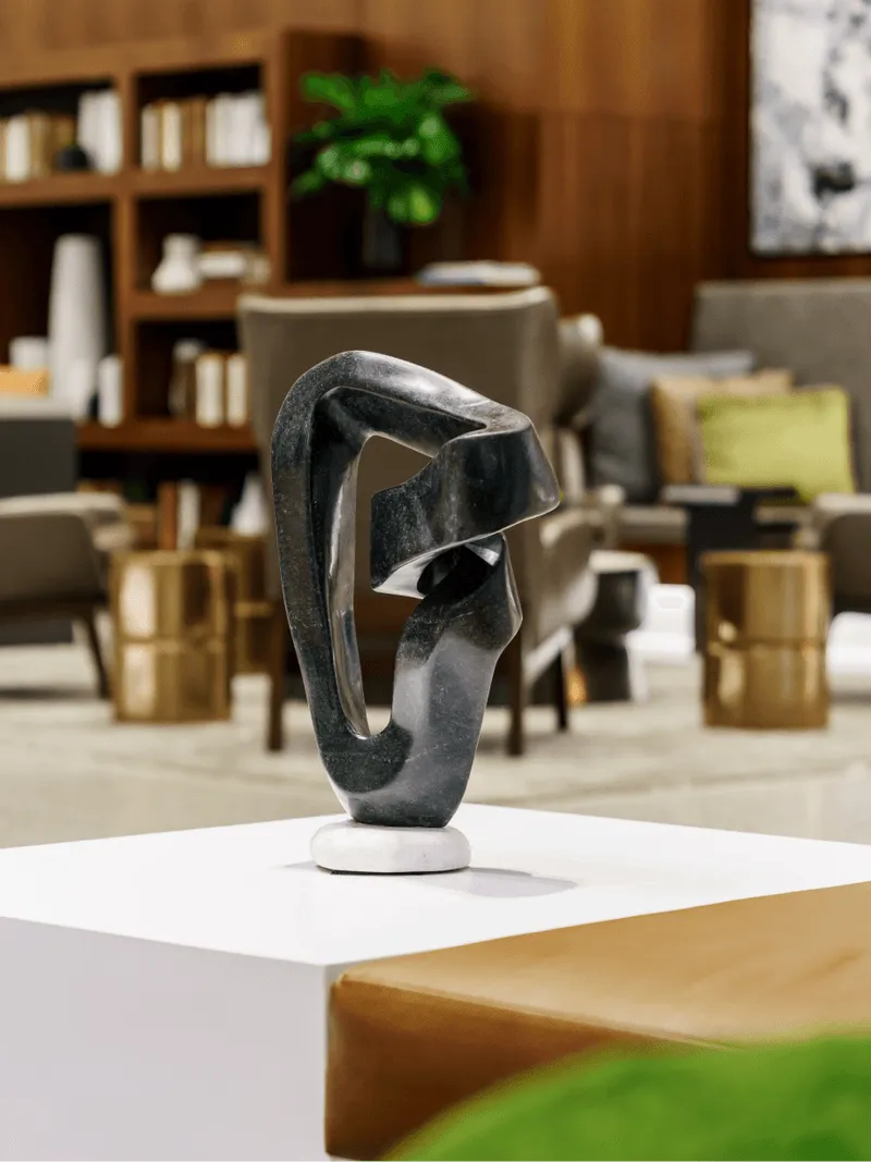 close up of black sculpture on pedestal