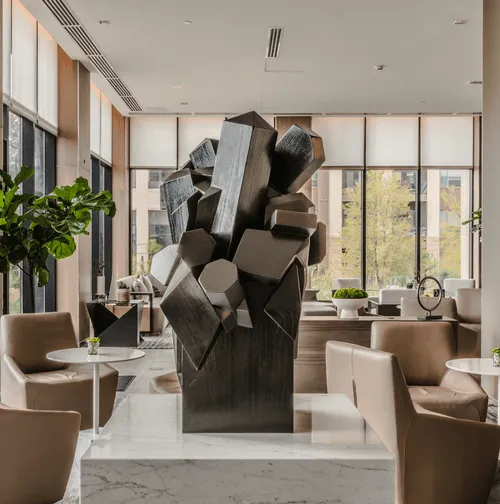 black sculpture on marble pedestal