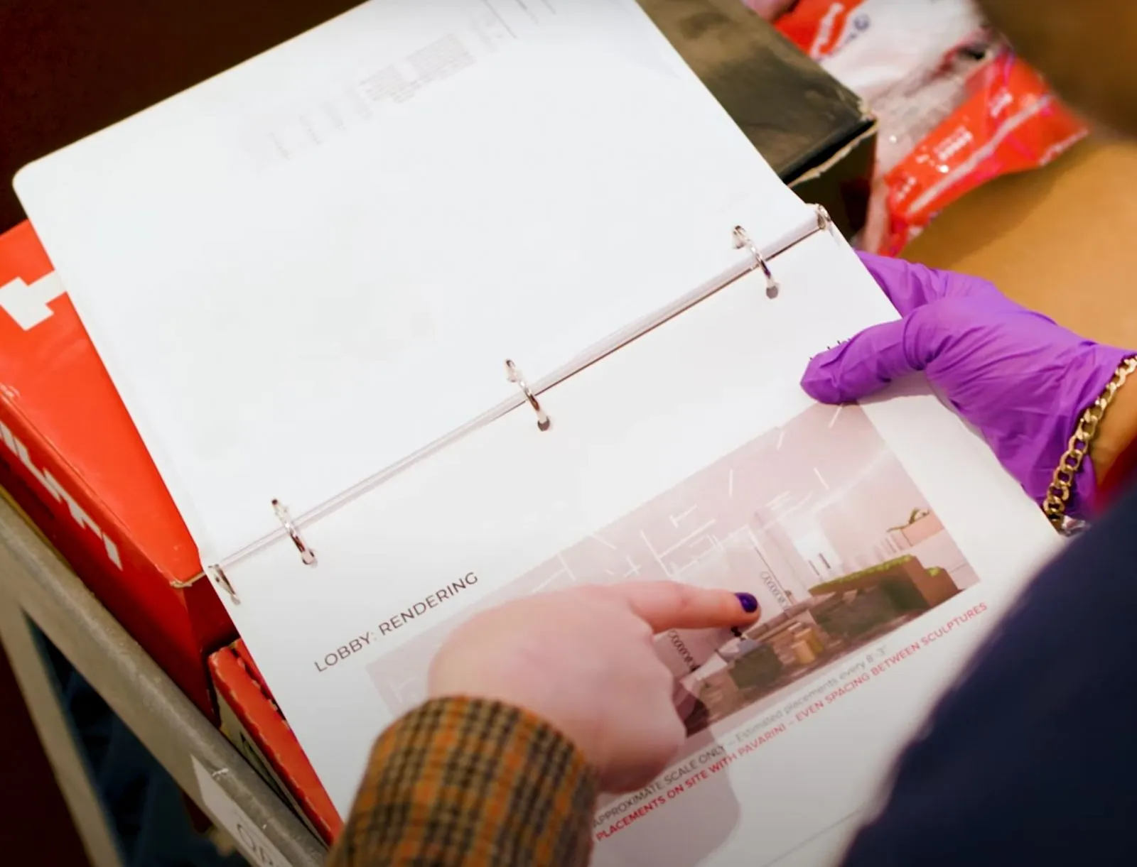 hand pointing to printed installation plan