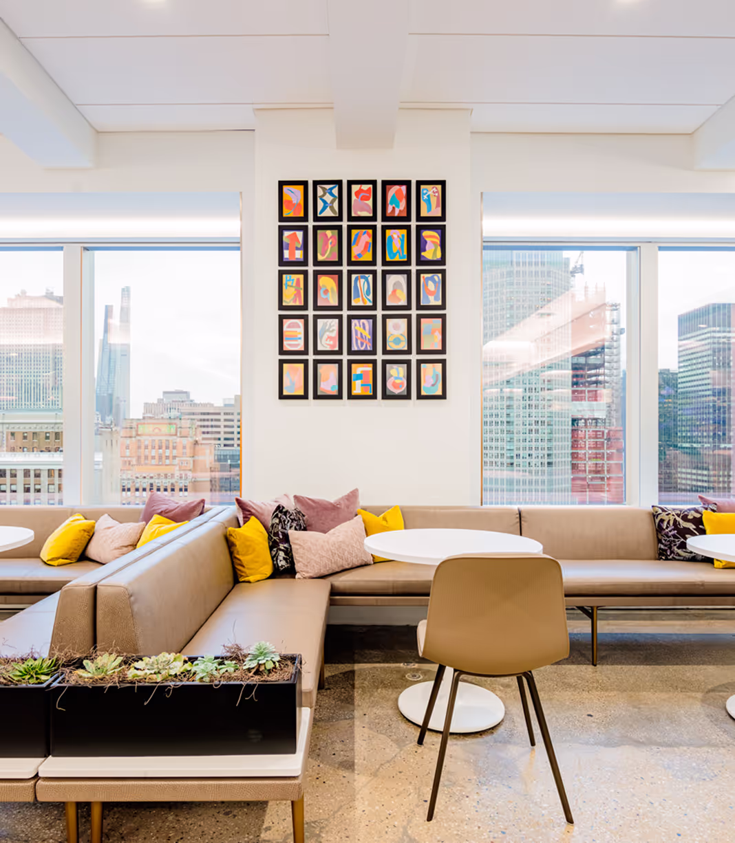 gallery wall of colorful art prints in allspring office