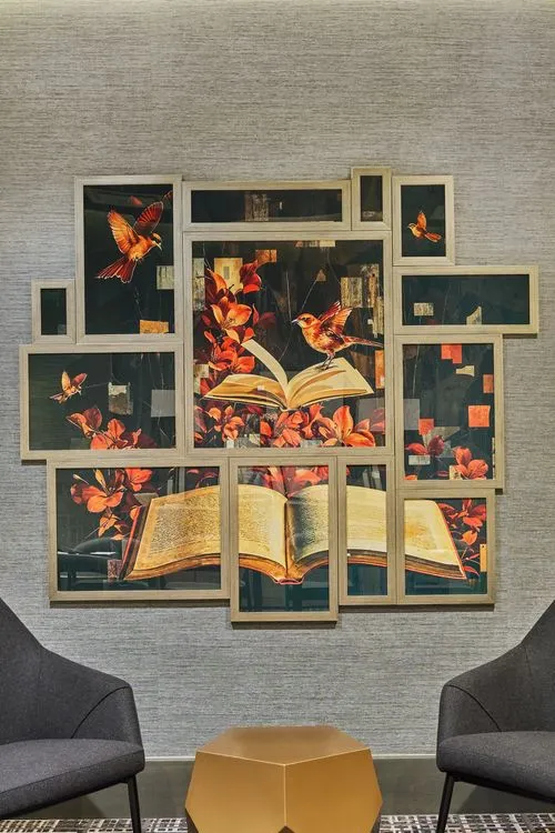 art piece showing a book across multiple frames on a wall