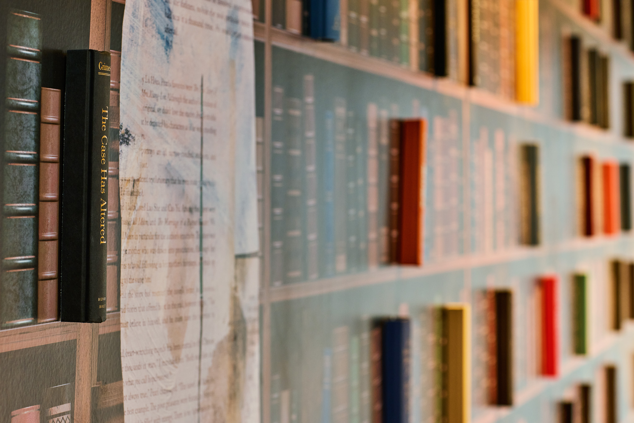 closure up of books coming out of the wall from a library wall vinyl art installation