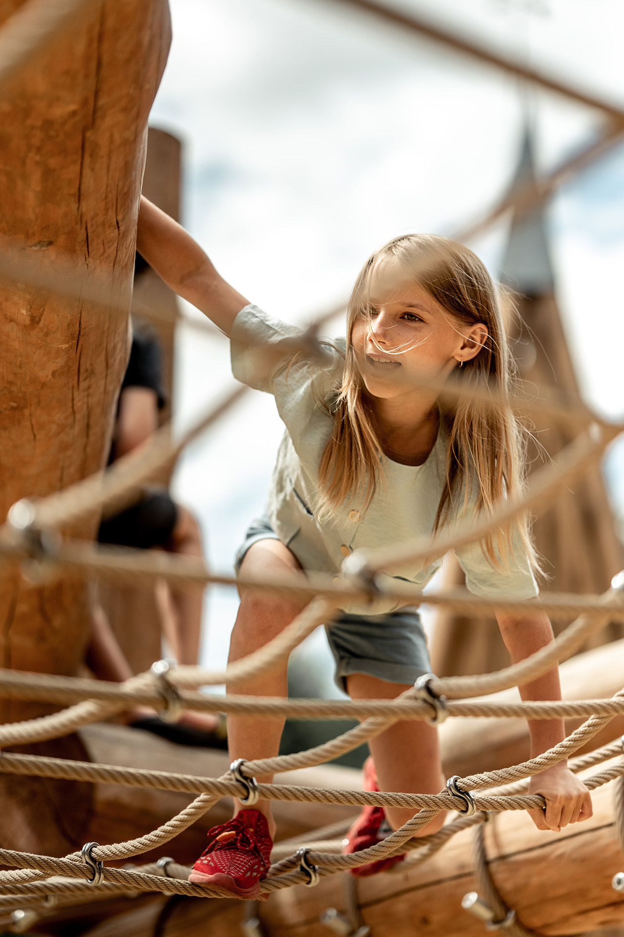 stock photo of girl playing on a climbing structure 