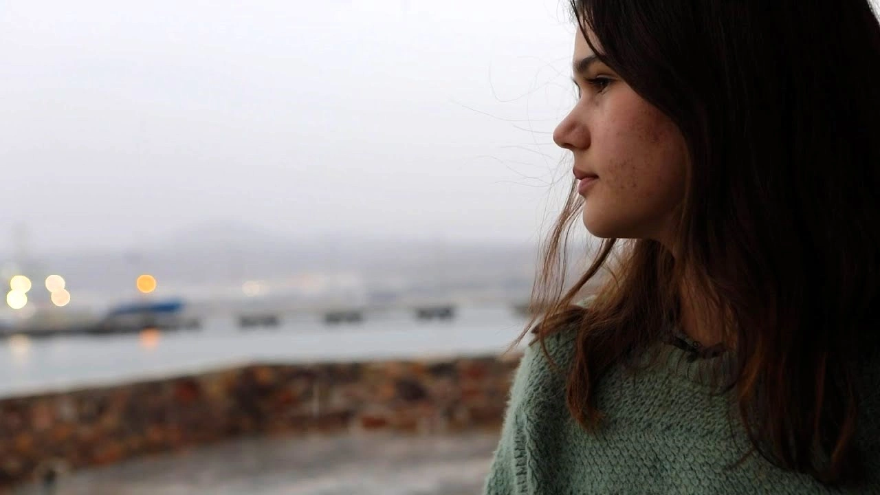 A girl is looking at the side