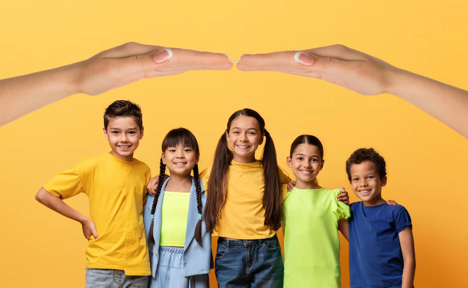Two hands forming a protective roof shape over paper cutouts of two adults and one child holding hands, glowing in golden sunlight.