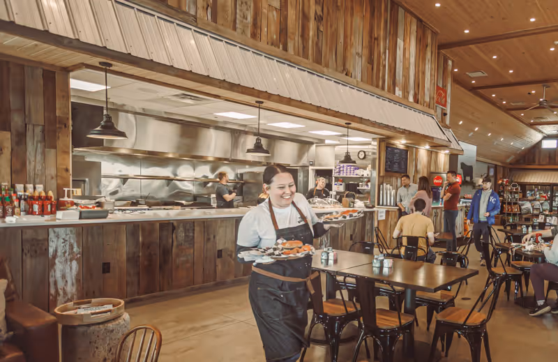 Server delivering food inside The 1:16 Marketplace restaurant in NW Missouri near Kansas City