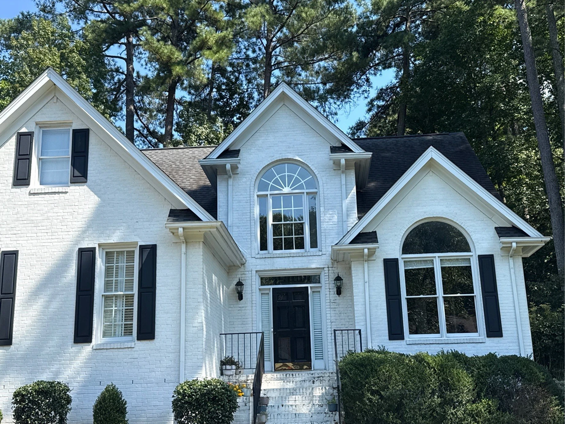Finished residential home exterior featuring professionally installed gutter system for improved water drainage and curb appeal.