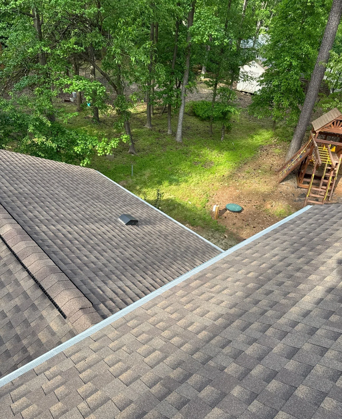 Freshly installed roof and gutter system on a residential home, providing improved protection and reliable rainwater drainage.