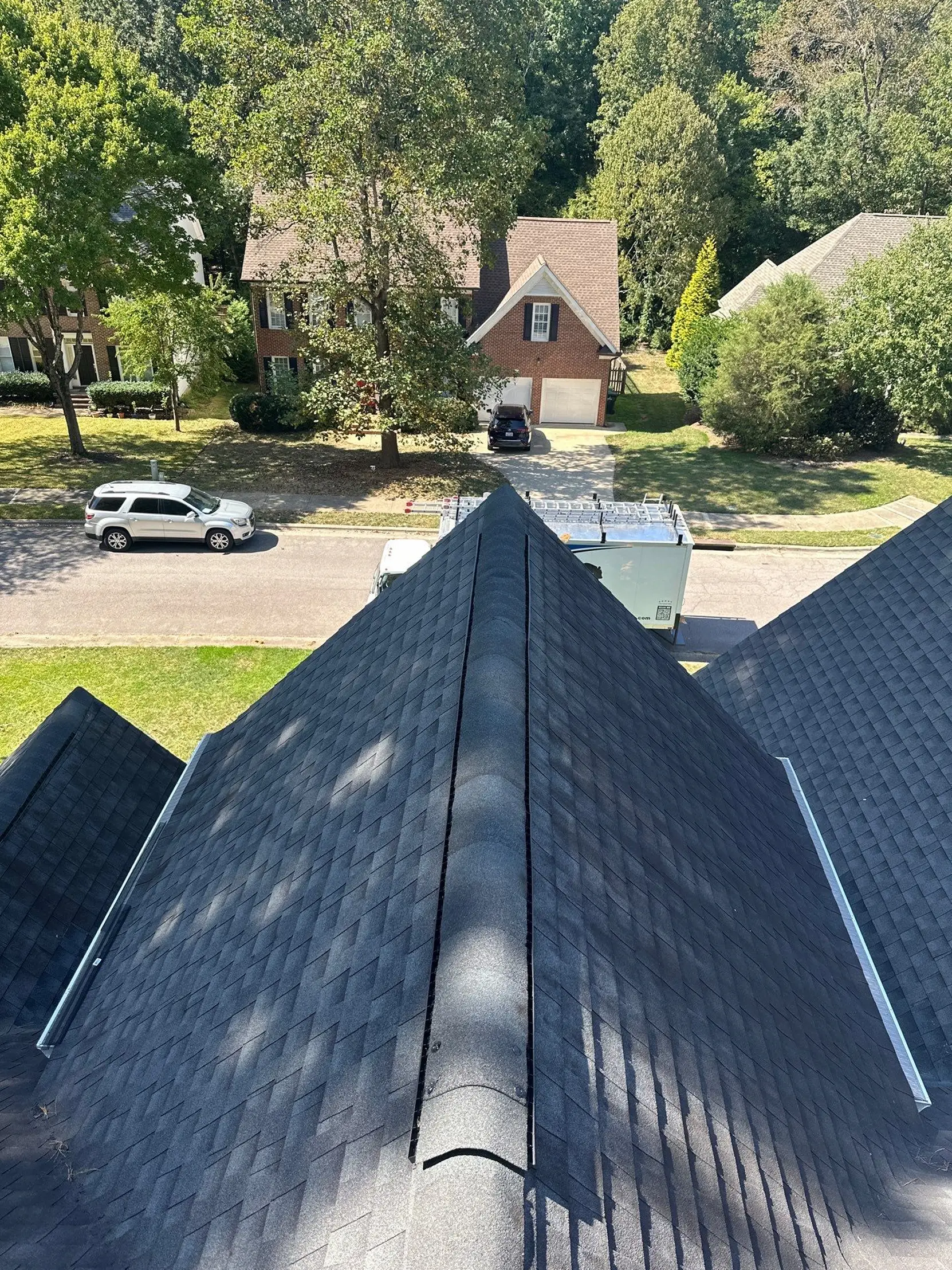 Finished residential roofing project with clean ridge lines and a uniform surface, providing durable protection and long-term performance.