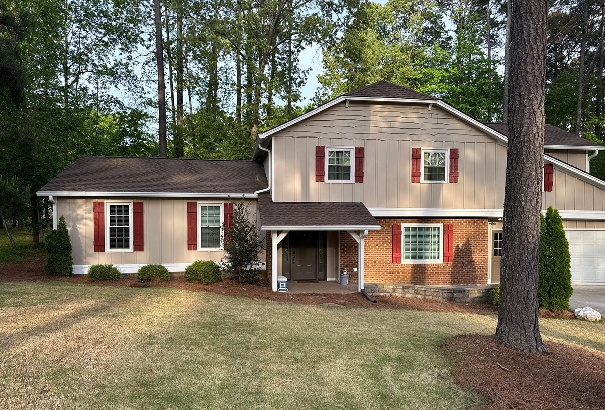 Residential home exterior featuring updated shutters, siding, and trim details.