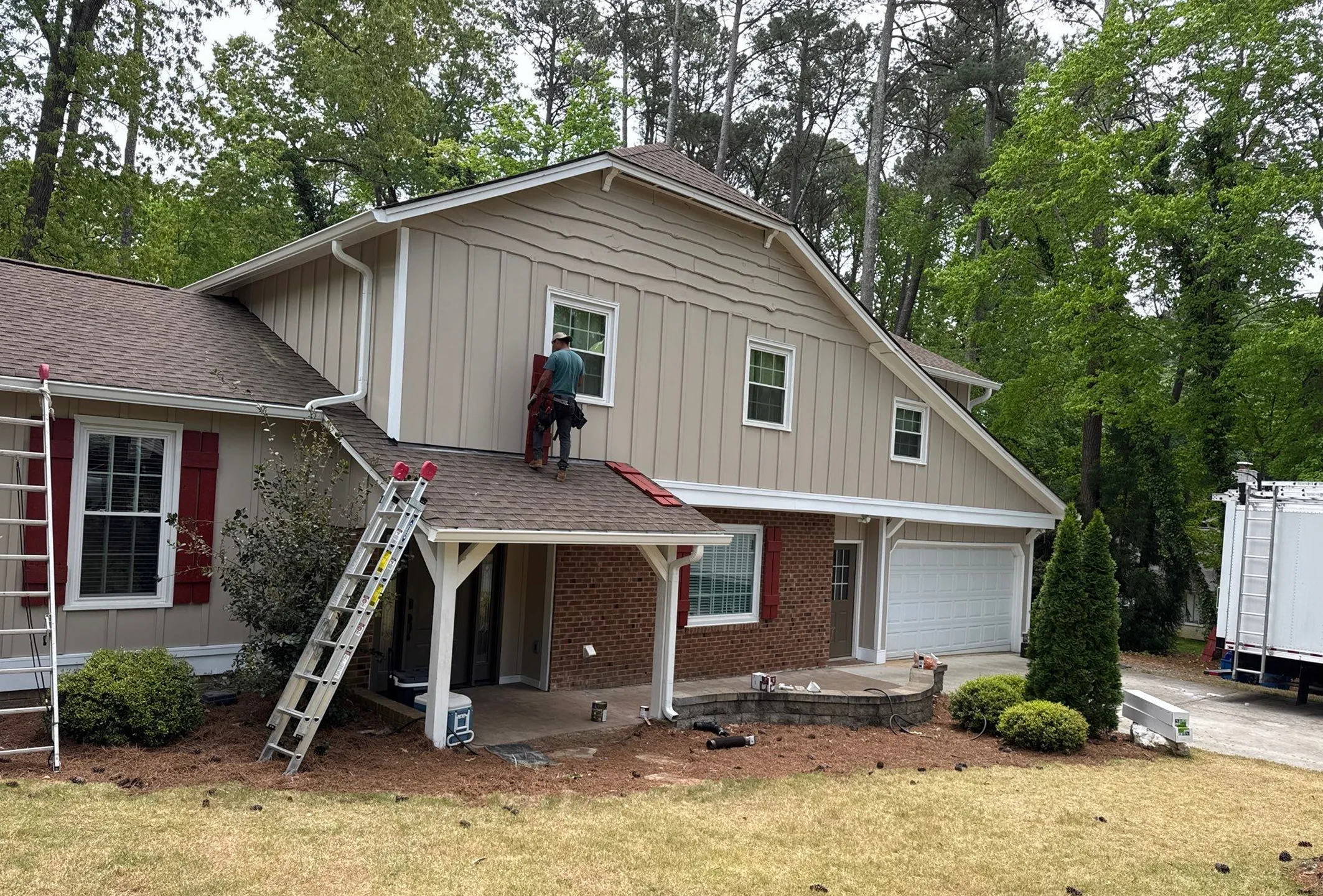 Home exterior pictured mid-project with ongoing exterior repair work.