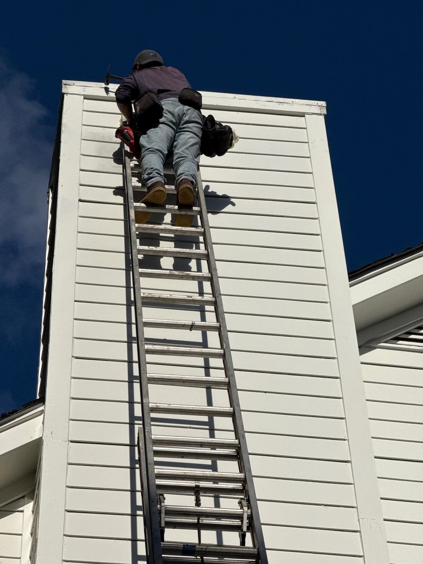 Exterior siding maintenance and repair work underway on a home.