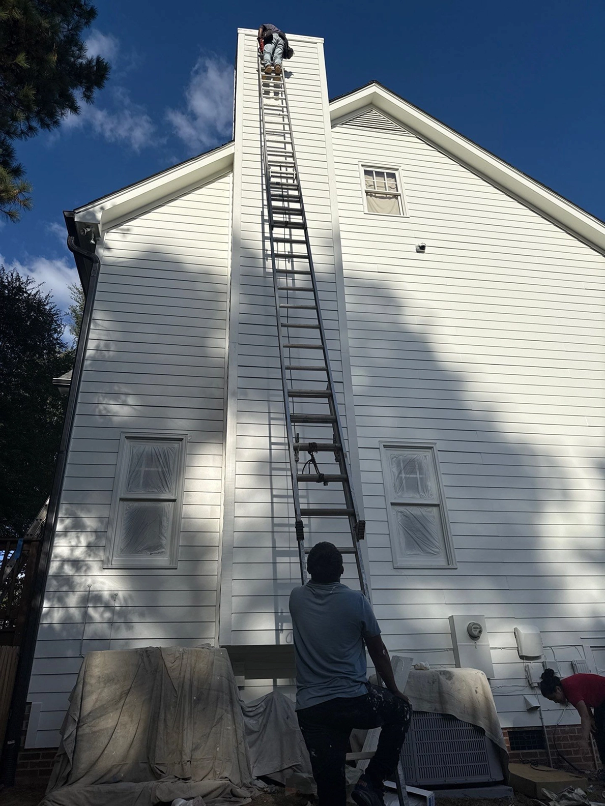 Large-scale exterior siding repair underway on a residential property.
