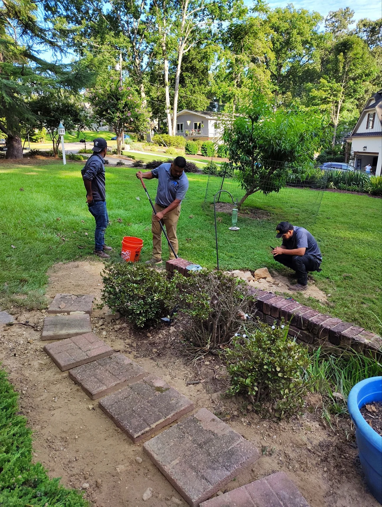 Residential outdoor repair involving brick and pathway areas.