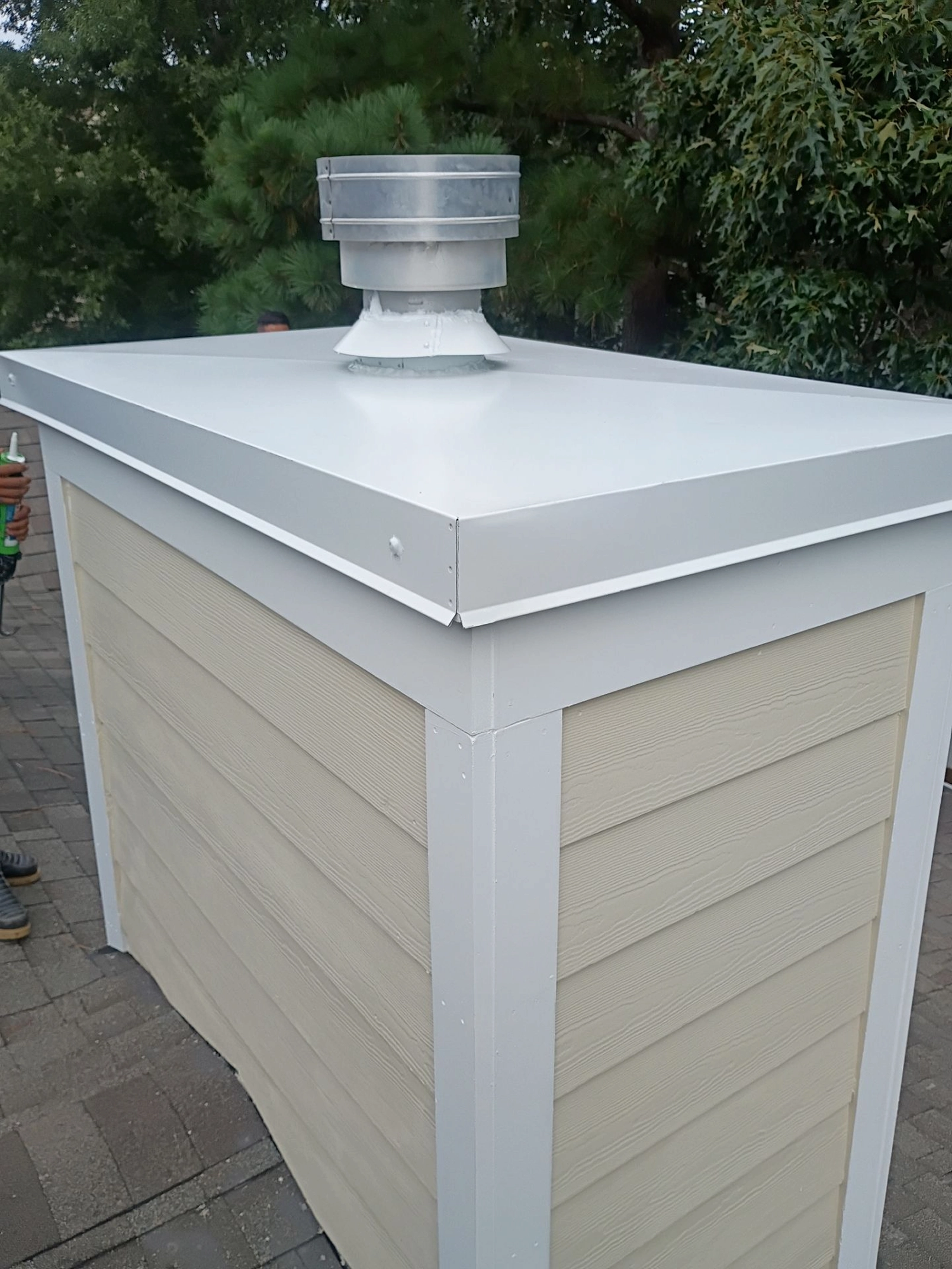 Chimney chase finished with a custom metal cap for added protection and durability.
