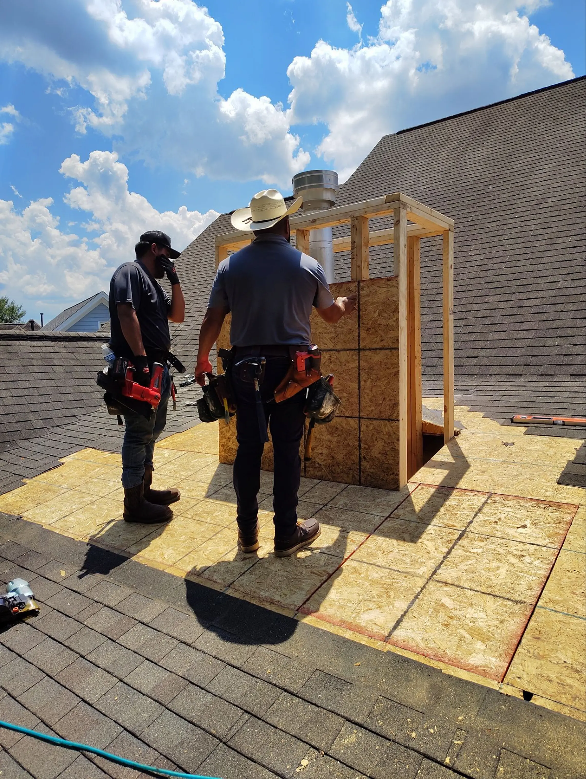 himney chase rebuild showing new wood framing around the flue and freshly installed roof sheathing