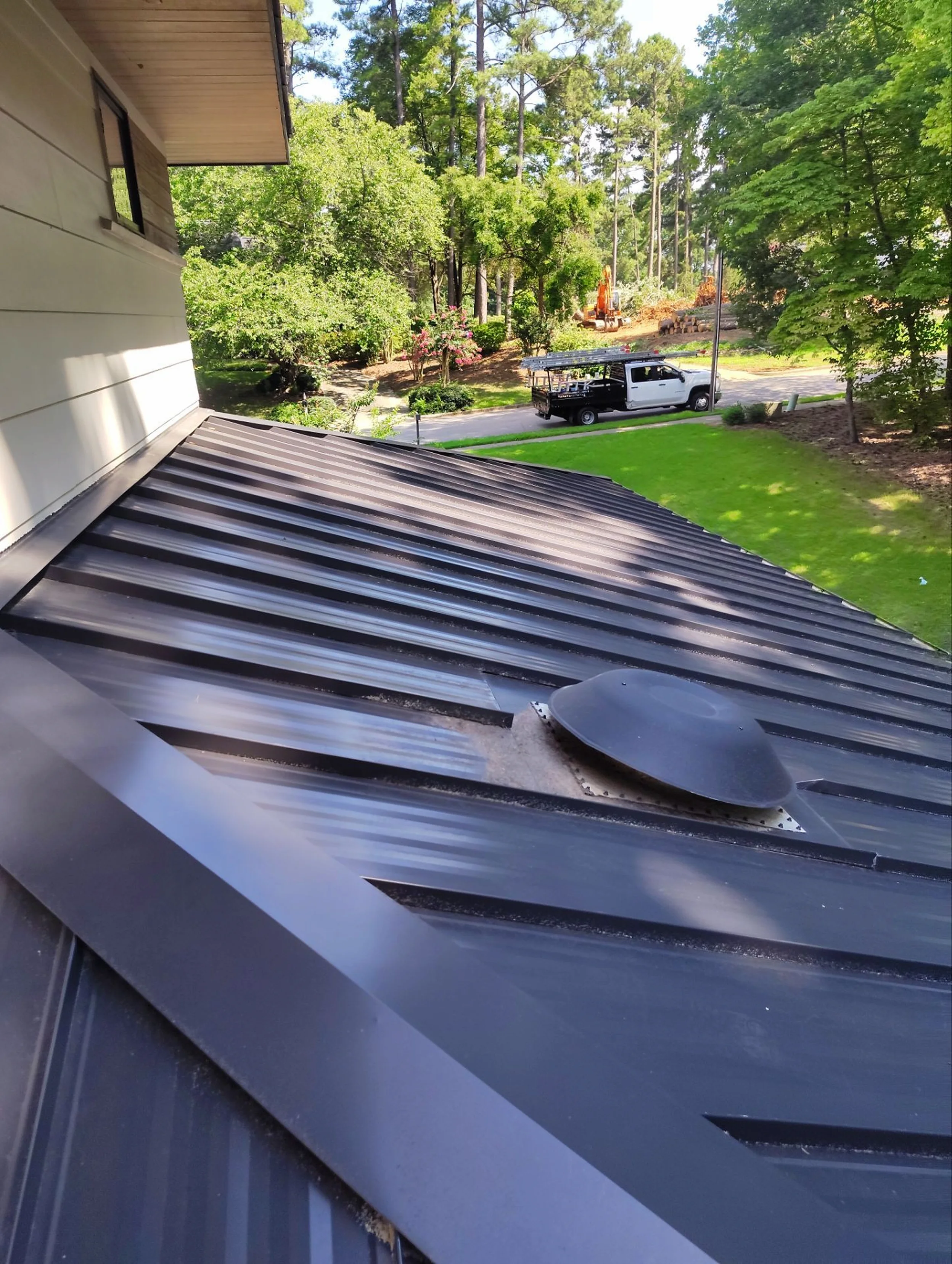 Metal roofing detail showing vent penetration and flashing