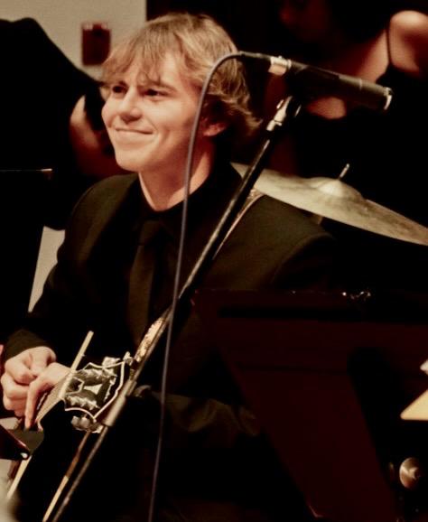 Noah Straus donning his Indiana Jones 2023 Dial of Destiny hat while standing next to the original hat worn by actor Harrison Ford