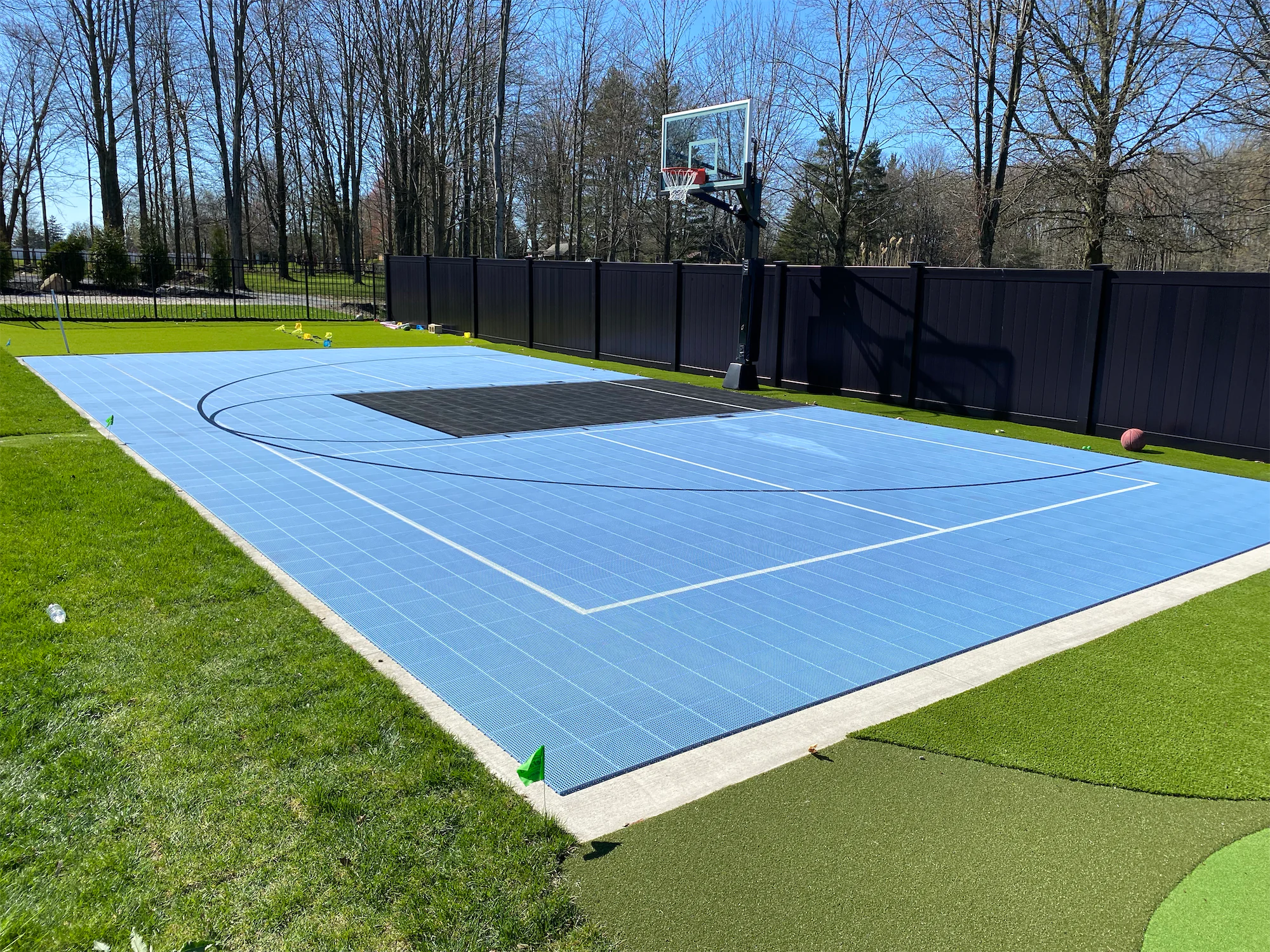 outdoor half basketball court with light blue flooring