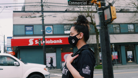 Uniformed Blackbird security guard patrolling street