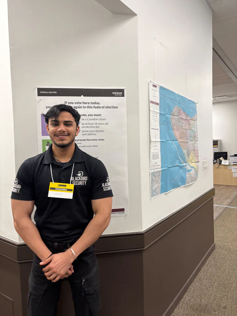 A Blackbird Security guard stands inside an Elections Canada office