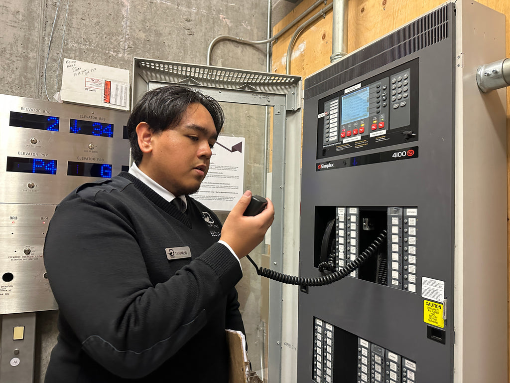 Blackbird Security guard communicating via radio in building control room