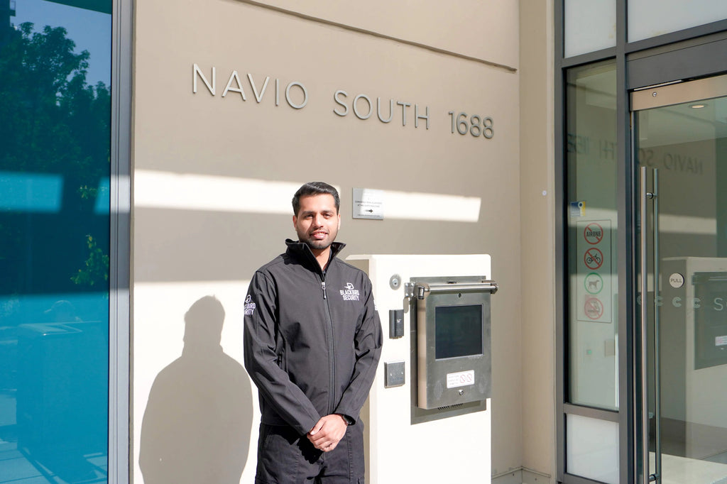 A Blackbird Security residential security guard stands outside Navio South in Vancouver