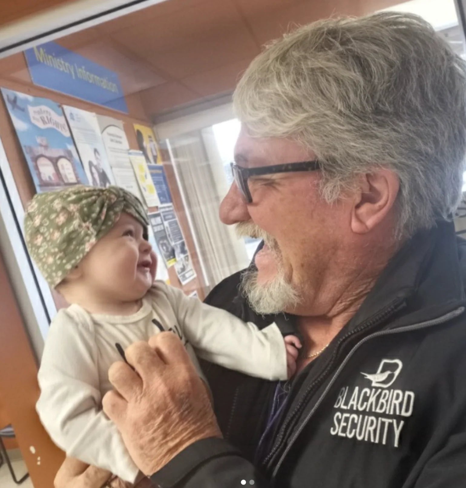Blackbird Security guard Rick Bunyan holds the baby whose life he saved by administering emergency CPR.